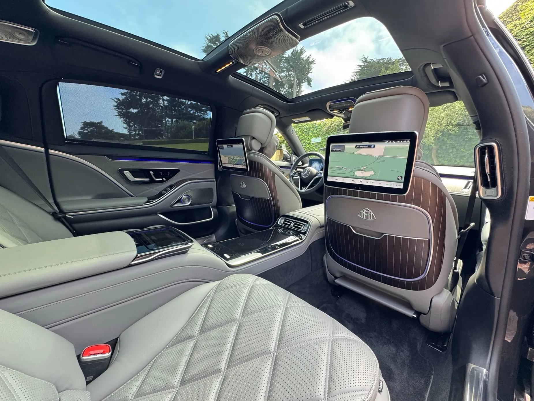 Premium Maybach rear cabin with reclining leather seating and entertainment screens